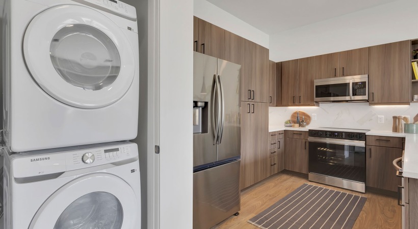 Well-lit kitchen with ample counter space and a laundry space